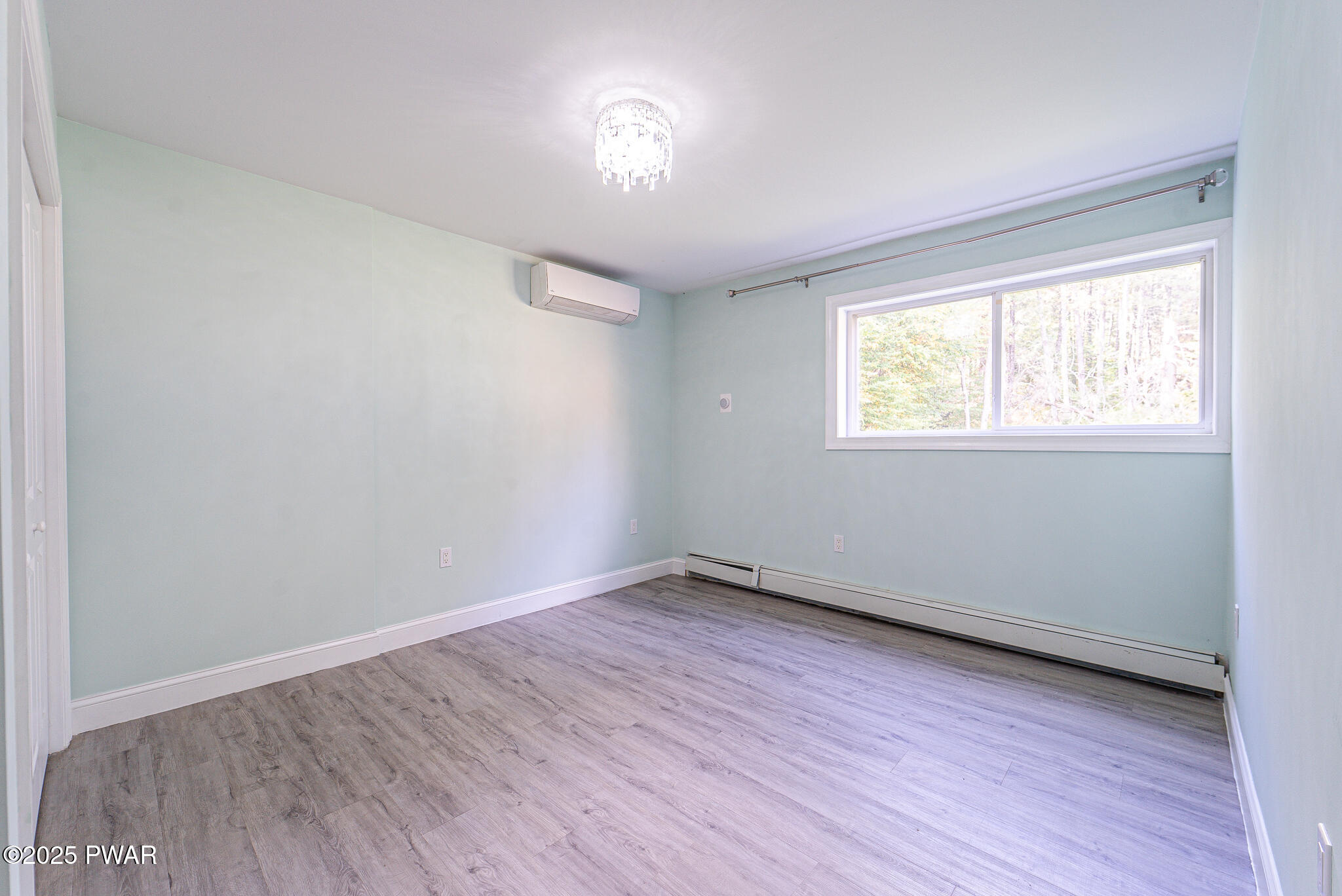 153 Hatton Road Hawley, PA 18428 - Photo 27 of 38 an empty room with wooden floor and windows