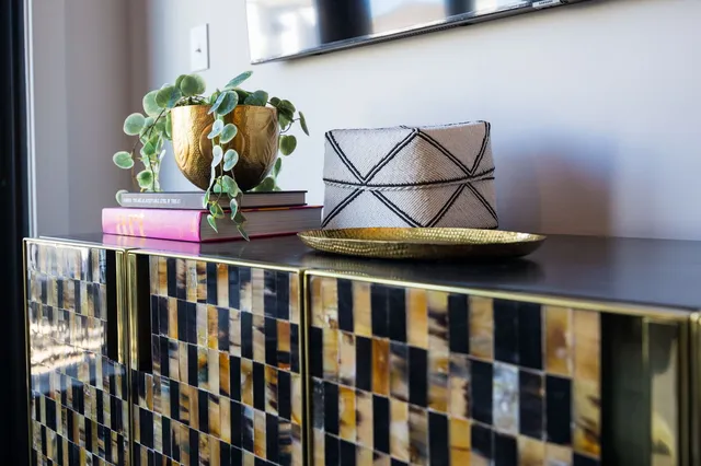 a kitchen with stainless steel appliances granite countertop a stove a sink a oven a dining table and chairs with wooden floor