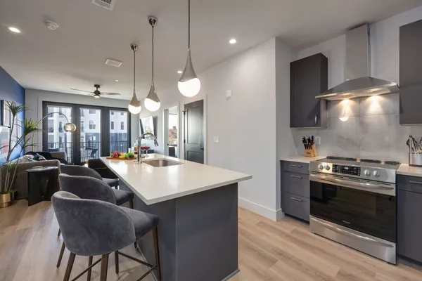 a stove top oven sitting inside of a kitchen