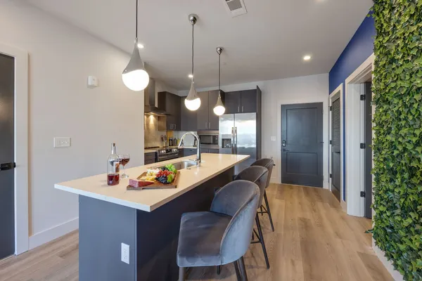 a kitchen with a refrigerator and a stove
