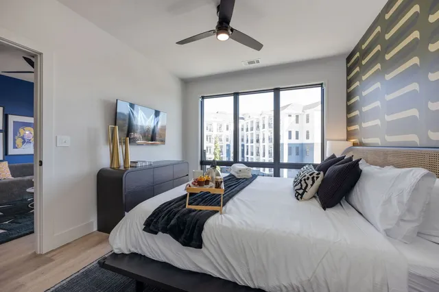 a living room with furniture flowerpot and window