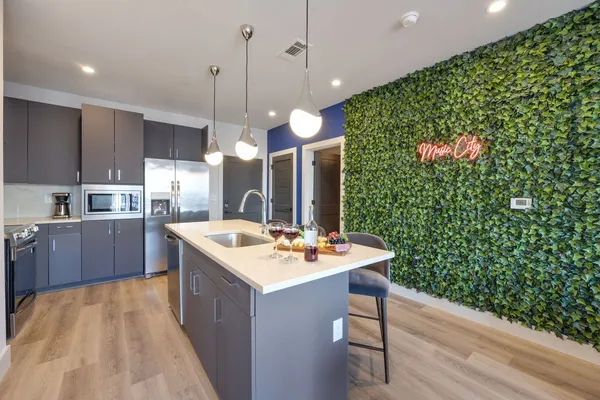 a kitchen with sink cabinets and wooden floor