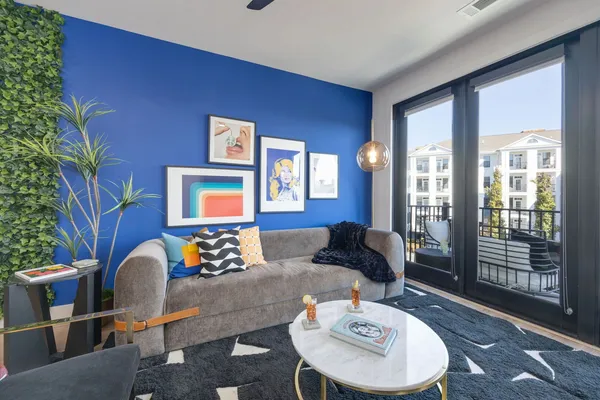 a living room with furniture and wooden floor