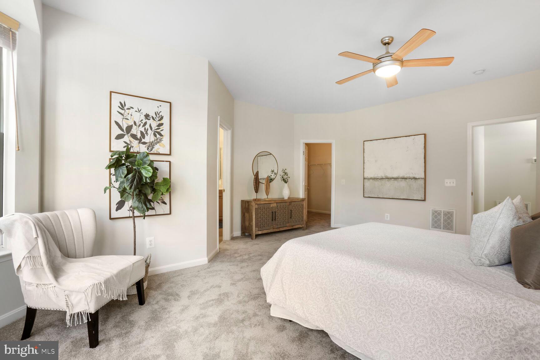 3948 Solstice Lane Dumfries, VA 22025 - Photo 11 of 27 a spacious bedroom with a bed and a couch