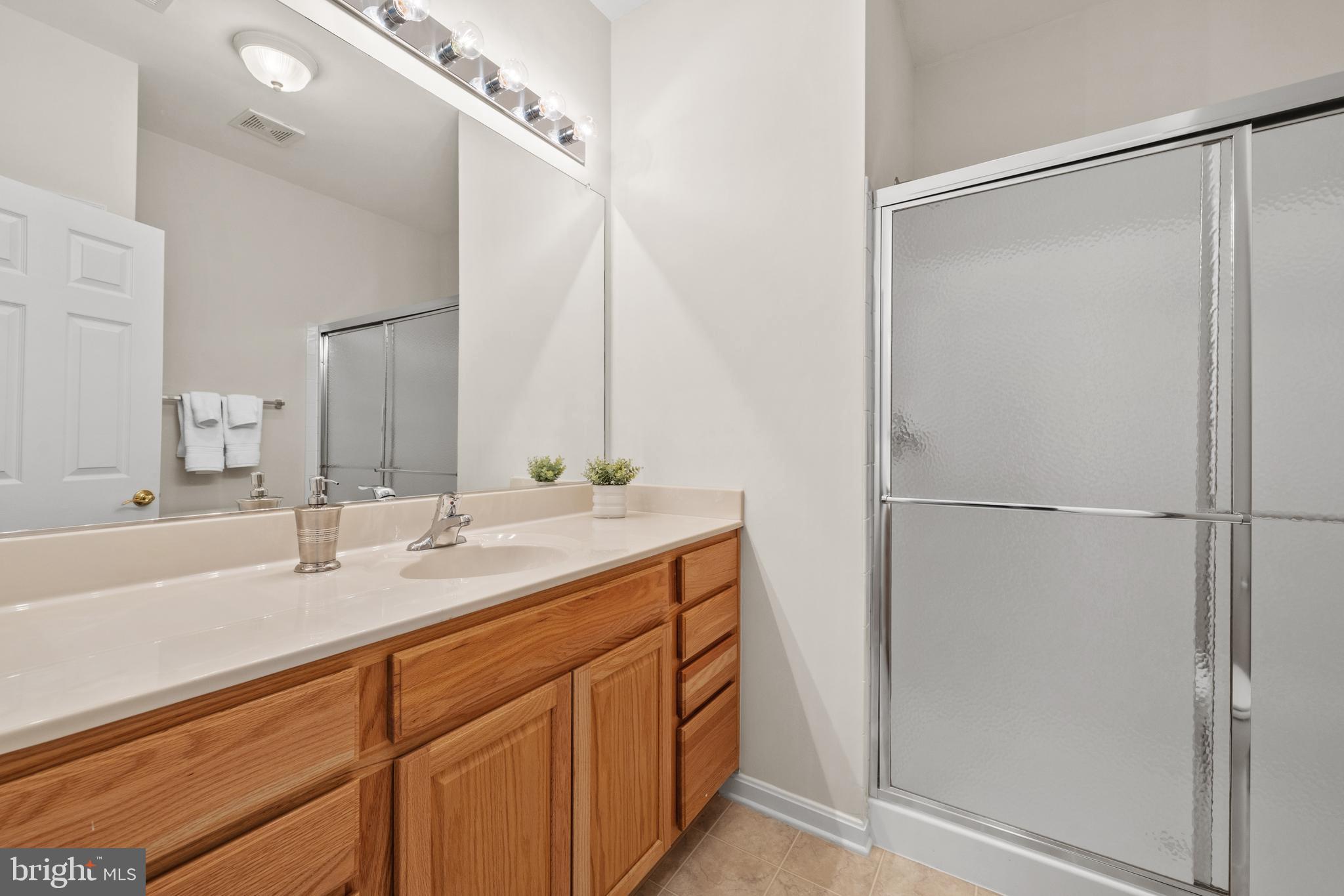 3948 Solstice Lane Dumfries, VA 22025 - Photo 15 of 27 a bathroom with a double vanity sink and a mirror