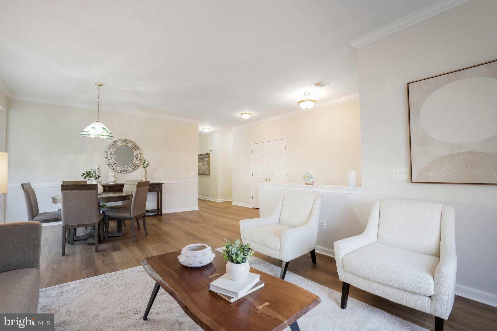 3948 Solstice Lane Dumfries, VA 22025 - Photo 4 of 27 a living room with furniture a dining table and a chandelier