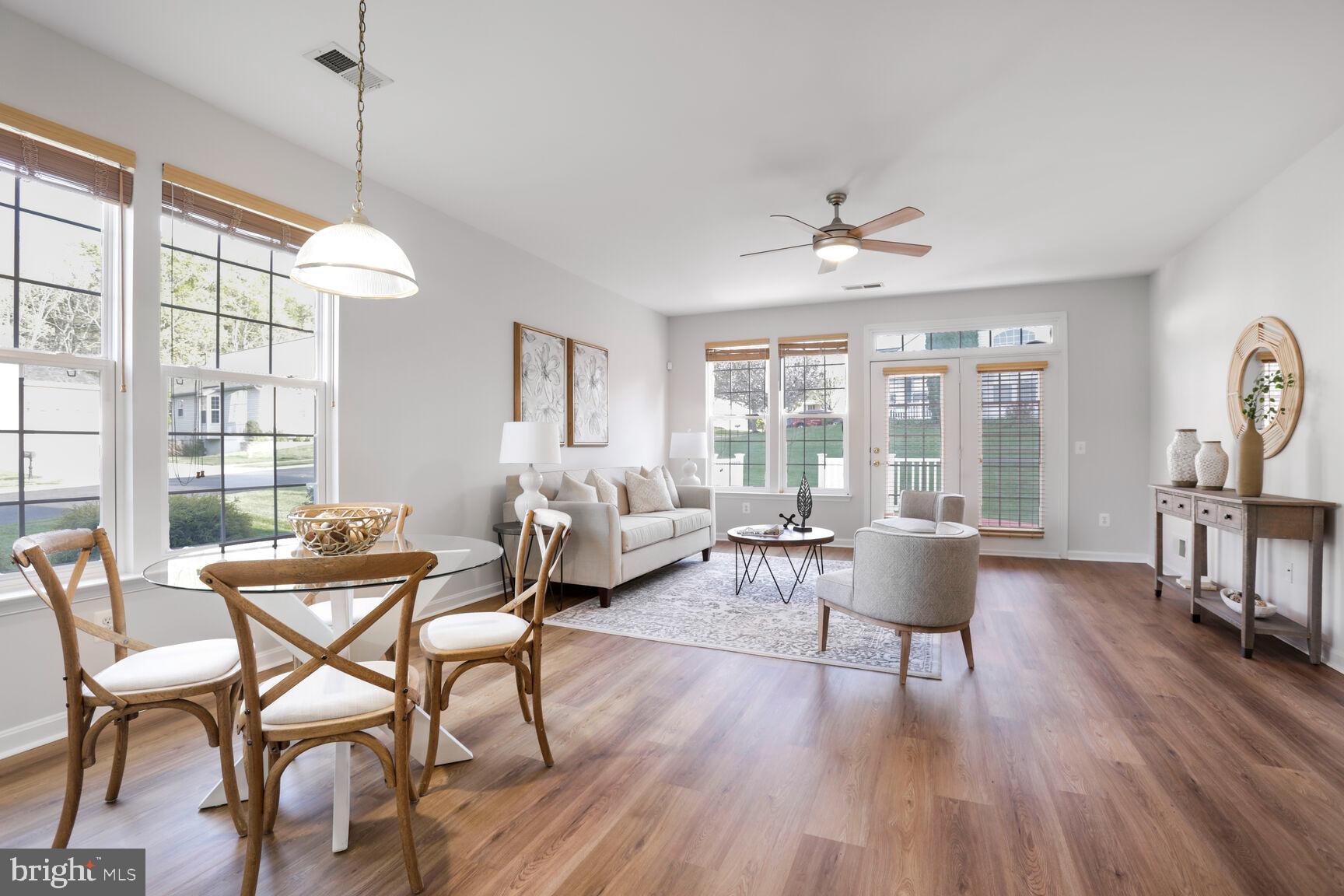 3948 Solstice Lane Dumfries, VA 22025 - Photo 5 of 27 a dining room with furniture a chandelier and wooden floor