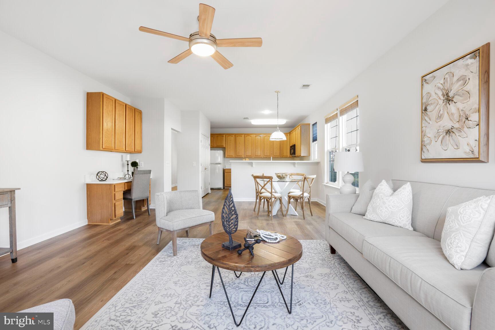 3948 Solstice Lane Dumfries, VA 22025 - Photo 6 of 27 a living room with furniture a rug and a chandelier