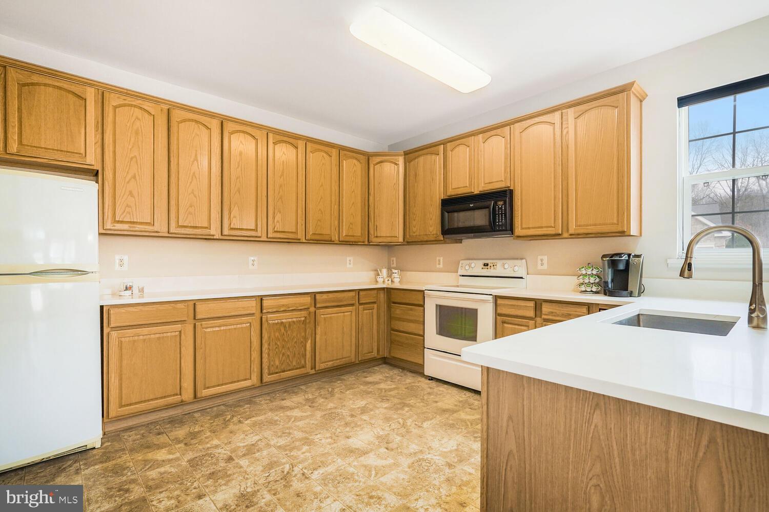 3948 Solstice Lane Dumfries, VA 22025 - Photo 7 of 27 a kitchen with stainless steel appliances granite countertop a stove a sink dishwasher and a refrigerator