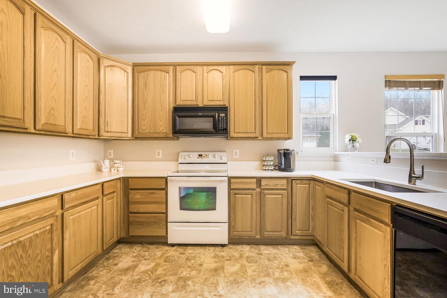 3948 Solstice Lane Dumfries, VA 22025 - Photo 8 of 27 a kitchen with stainless steel appliances granite countertop a stove a sink and a microwave