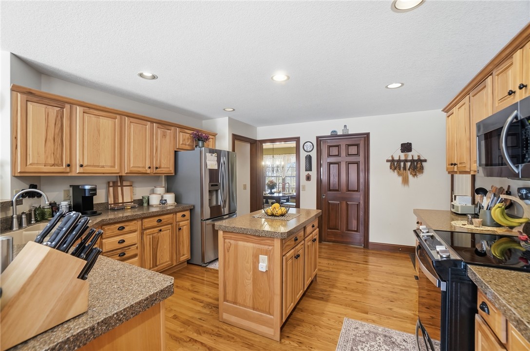 5300 Brookshire Lane Springfield, OH 45502 - Photo 17 of 56 This kitchen features a central island, ample cabinetry, and sleek appliances.