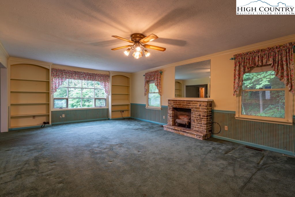 881 Queen Street Boone, NC 28607 - Photo 12 of 43 a view of an empty room with a window and fireplace