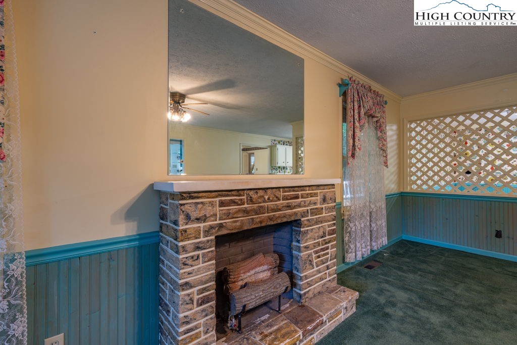 881 Queen Street Boone, NC 28607 - Photo 13 of 43 a kitchen with a fireplace and a cabinets