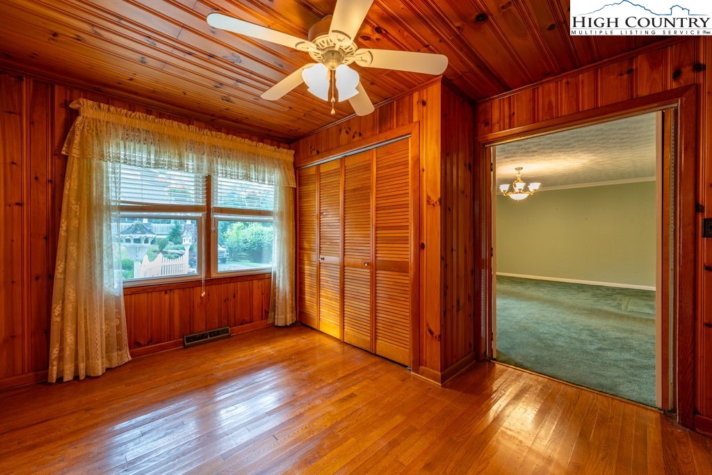 881 Queen Street Boone, NC 28607 - Photo 17 of 43 an empty room with wooden floor and windows