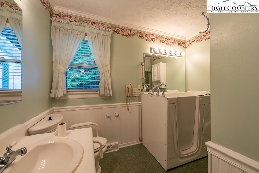 881 Queen Street Boone, NC 28607 - Photo 26 of 43 a bathroom with a sink mirror vanity and toilet