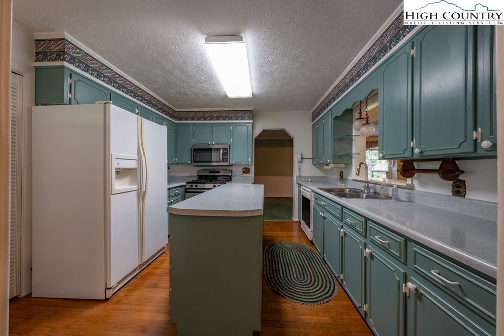 881 Queen Street Boone, NC 28607 - Photo 5 of 43 a kitchen with sink a refrigerator and cabinets