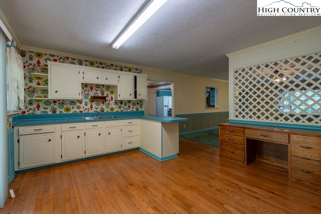 881 Queen Street Boone, NC 28607 - Photo 10 of 43 a kitchen with granite countertop white cabinets and white appliances