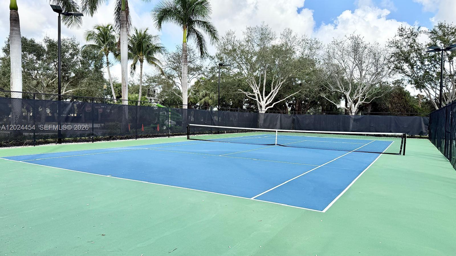 2727 Anzio Court, Unit 106 Palm Beach Gardens, FL 33410 - Photo 37 of 43 a view of an outdoor space and tennis court