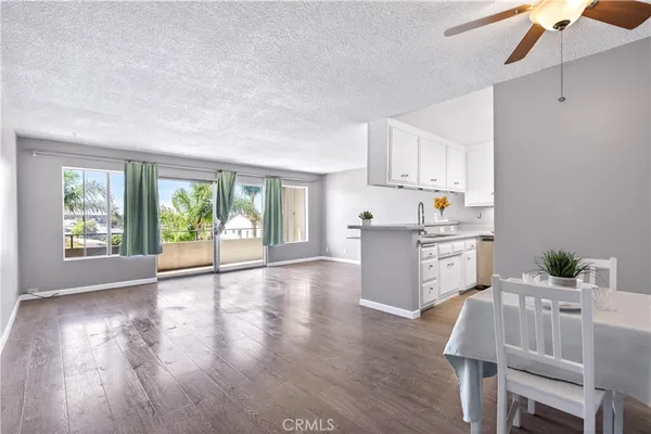 a kitchen with furniture and wooden floor