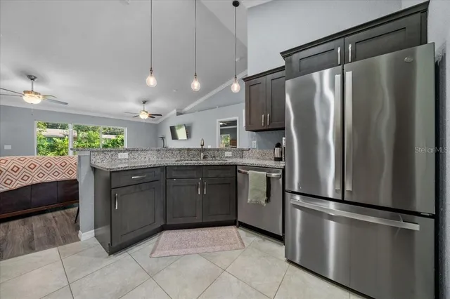 a kitchen with stainless steel appliances granite countertop a stove and a microwave