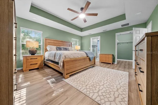 a bedroom with a bed and a tv on the dresser