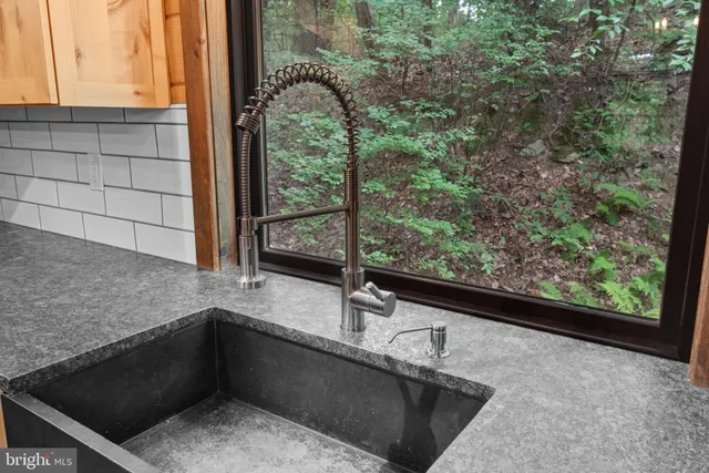 a kitchen with a sink and large window