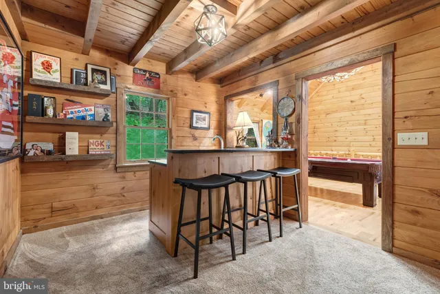 a view of a porch with chairs and floor to ceiling window