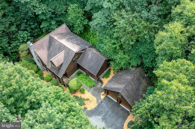 an aerial view of a house with yard