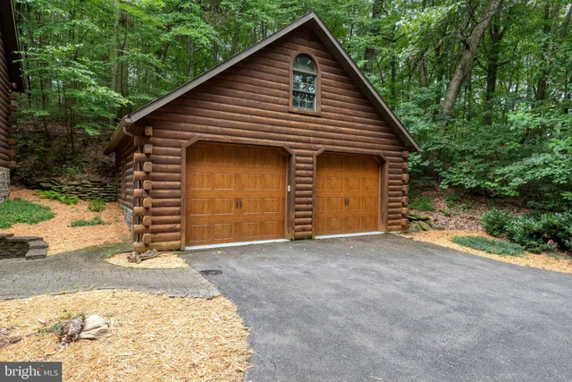 a view of a house with backyard and garage