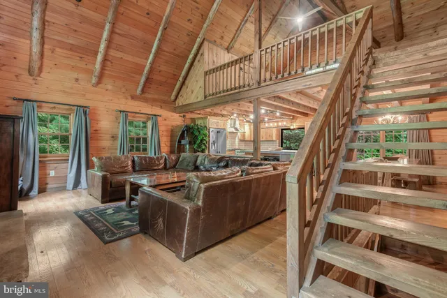 a living room with furniture and a floor to ceiling window