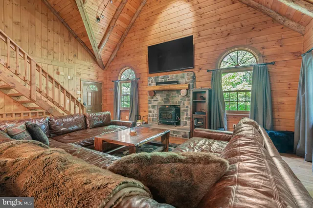 a living room with furniture fireplace and flat screen tv