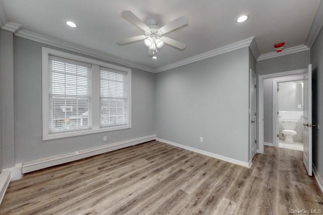 724 Howell Avenue, Unit E Riverhead, NY 11901 - Photo 7 of 10 wooden floor in an empty room with a window