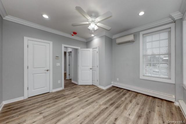 724 Howell Avenue, Unit E Riverhead, NY 11901 - Photo 9 of 10 a view of an empty room with wooden floor and a window