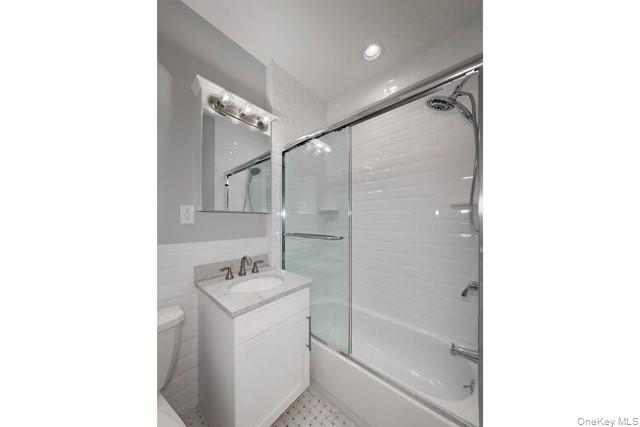 724 Howell Avenue, Unit E Riverhead, NY 11901 - Photo 10 of 10 a bathroom with a sink a mirror and a shower