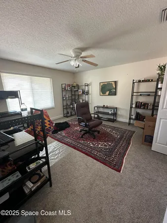 a living room with furniture a flat screen tv and a table
