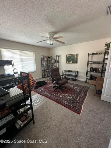 a living room with furniture a flat screen tv and a table