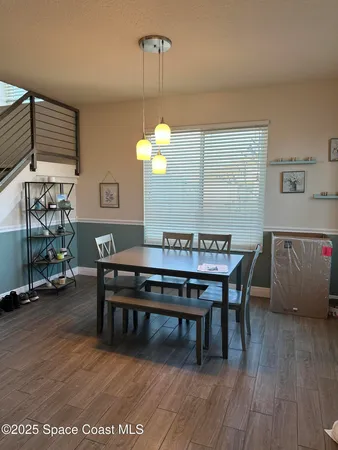 a view of a dining room with furniture and wooden floor