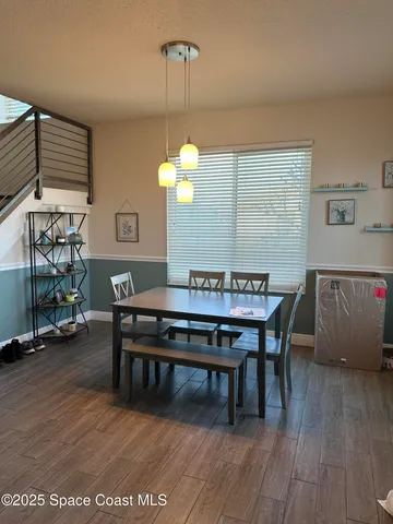 a view of a dining room with furniture and wooden floor