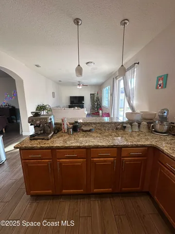 a kitchen with lots of counter space and wooden floor