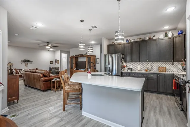 a large kitchen with kitchen island a large island in the center
