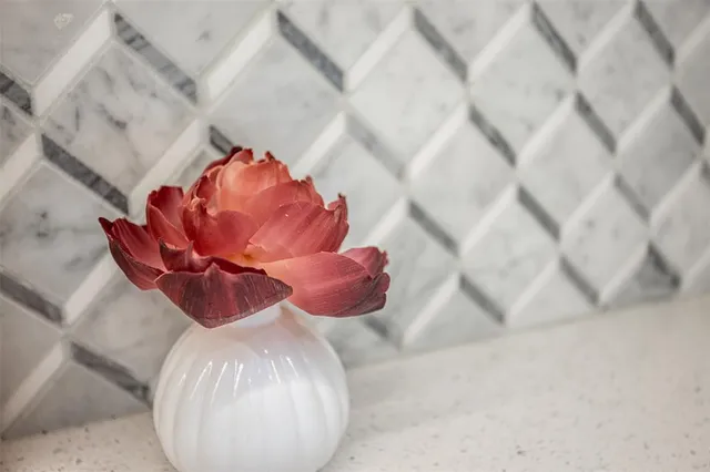 a close view of flowerpot sitting on wooden floor