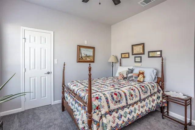 a bedroom with a bed and a painting on the wall