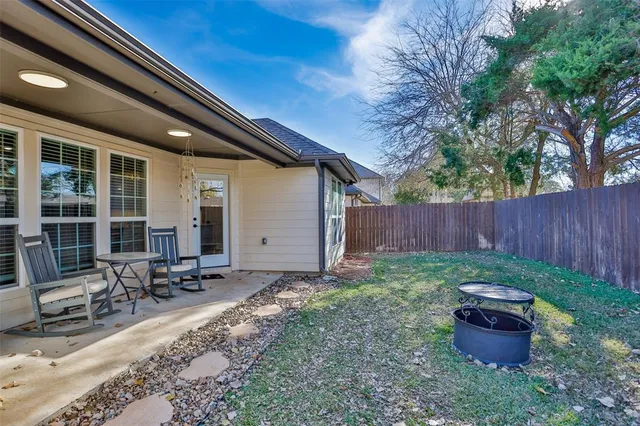 a backyard of a house with outdoor seating