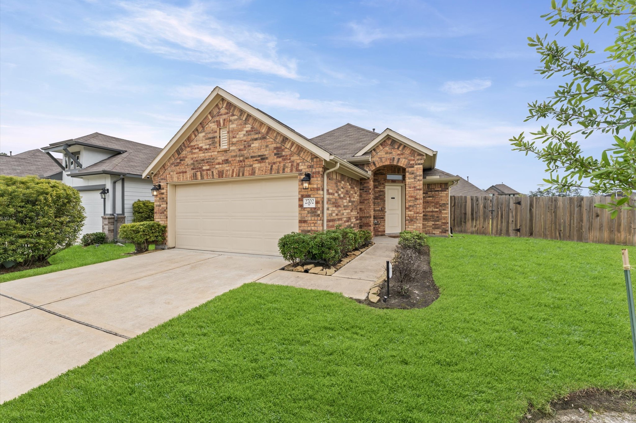 2702 Meadow View Lane Conroe, TX 77385 - Photo 3 of 26 a view of a house with backyard and a garden