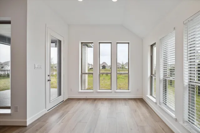 a view of an empty room with glass door and balcony