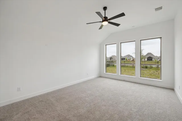 a view of a livingroom with a ceiling fan and window