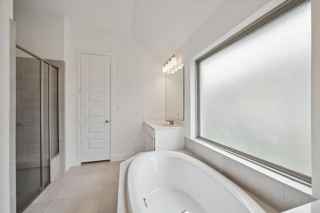 a bathroom with a tub and shower
