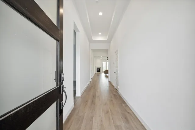 a view of a hallway with wooden floor