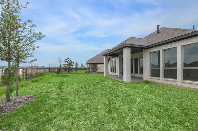 a view of a house with yard and sitting area