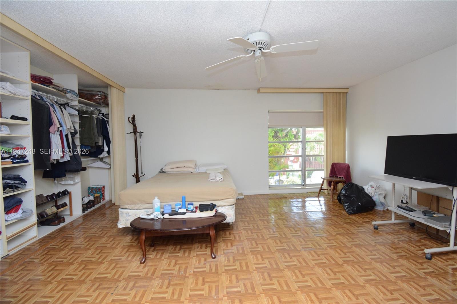 13935 Southwest 84th Street, Unit 905 Miami, FL 33183 - Photo 16 of 33 a living room with furniture a flat screen tv and a window